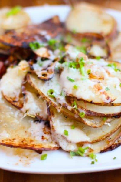 The ultimate hangover cure is thinly sliced potatoes with savory onions topped off with gooey and salty cheese. Bye bye hangover!