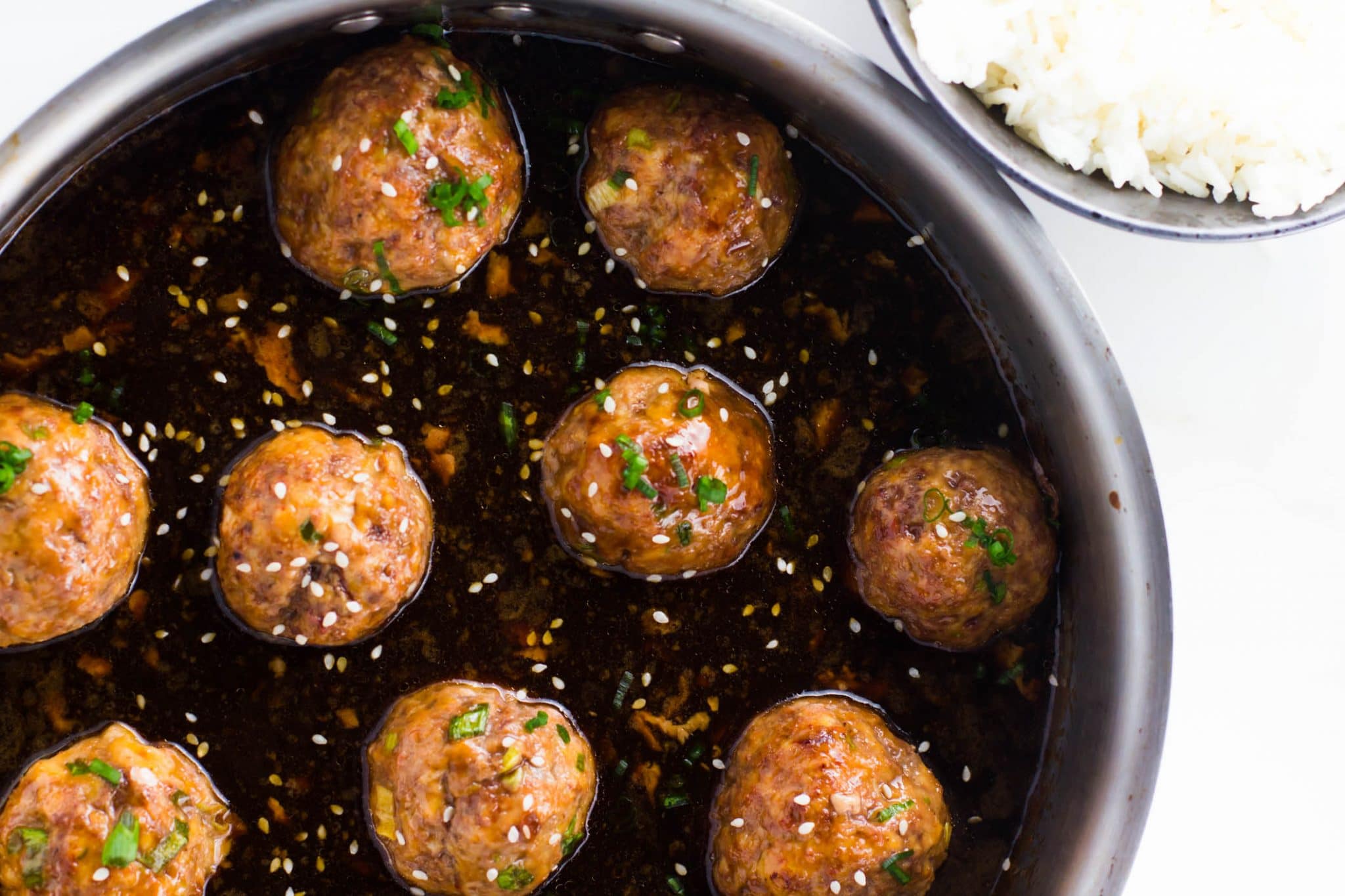 These fun and easy spicy Asian meatballs are juicy, tangy and spicy! They are baked right in the oven and dipped in an uber flavorful glaze to create the perfect party appetizer or a quick dinner!!!