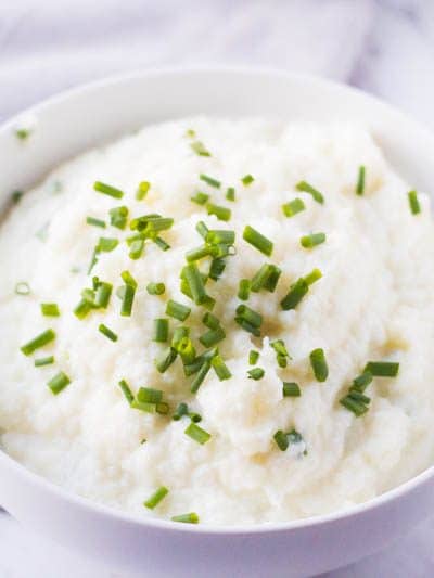 This super creamy mashed cauliflower puree is better than potatoes!  With plenty of garlicky flavor and none of the carbs, these delicious side dish is the perfect add on to any guilt free dinner!