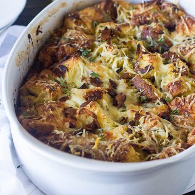 When dressing or stuffing just does not make the cut, make this glorious Cheesy Bacon Bread Pudding instead! Filled with sweet leeks, smoky bacon and salty Parmesan cheese this incredibly fast and delicious recipe will be the new go to for all your Thanksgiving and holiday must haves!