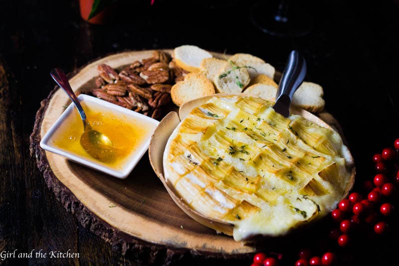 This gooey garlic baked brie has only 4 ingredients and takes 15 minutes to prepare! It comes out of the oven gooey and cheesy and loaded with rich garlic and herb flavors! This is the ultimate holiday appetizer for any party!