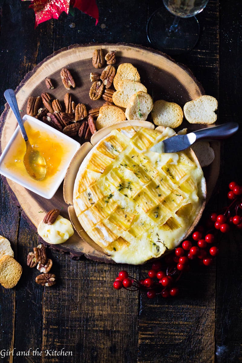 This gooey garlic baked brie has only 4 ingredients and takes 15 minutes to prepare! It comes out of the oven gooey and cheesy and loaded with rich garlic and herb flavors! This is the ultimate holiday appetizer for any party!