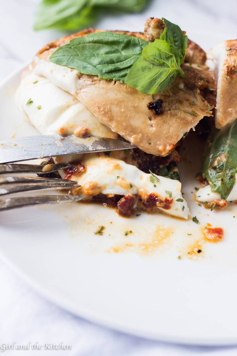 This Caprese Stuffed Chicken Breast is my solution when I want dinner on the table fast. Marinaded in a delicious balsamic dressing and stuffed with a sun-dried tomato mayonnaise, fresh mozzarella and plenty of basil, this super fast meal will leave everyone at the table asking for seconds!