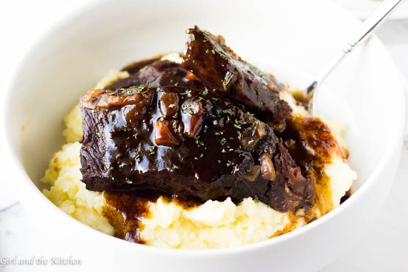 This super simple recipe for how to make Instapot short ribs will save your life! Super tender short ribs with a delicious red wine and balsamic sauce will steal the show at any dinner table yet they are simple enough to make for a Monday dinner!