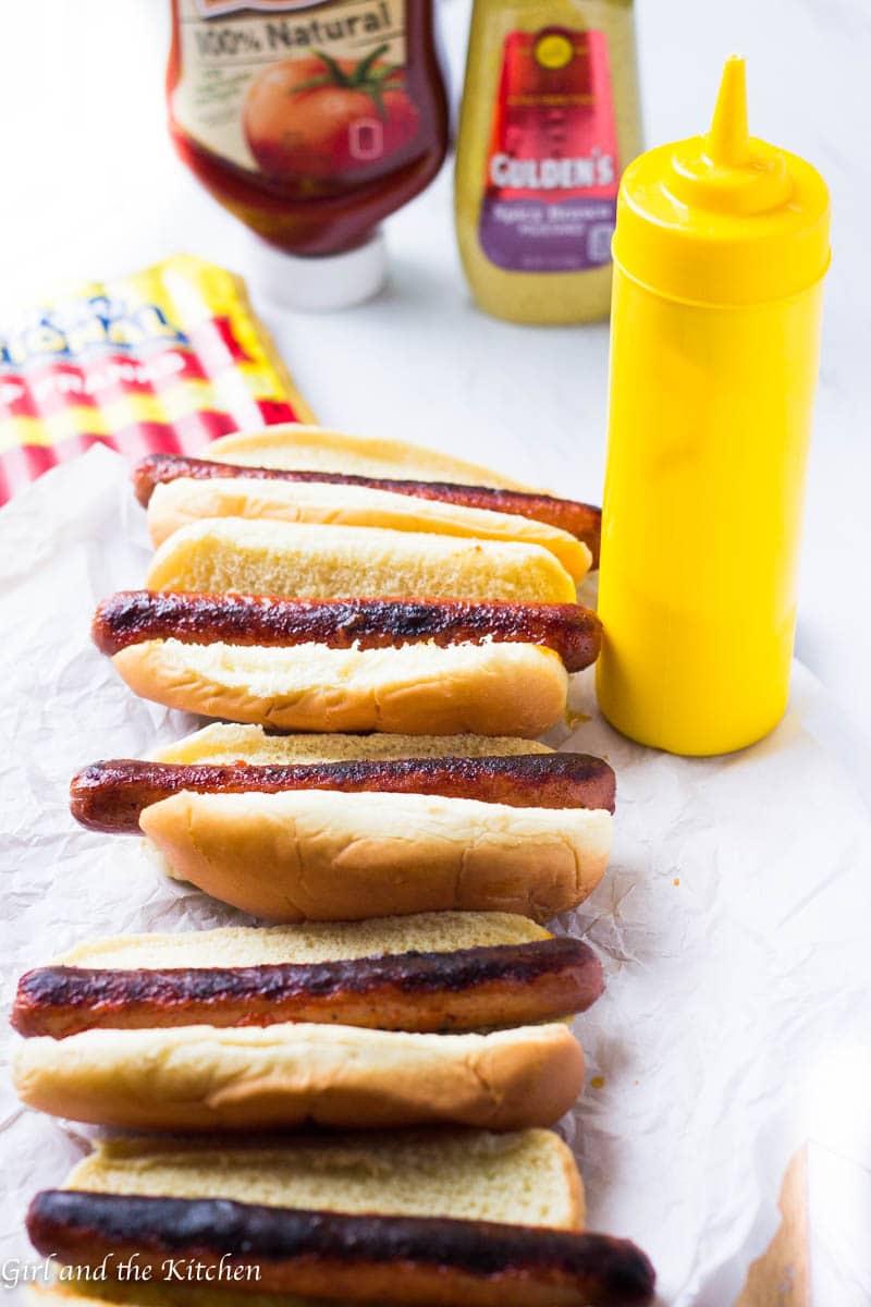 These perfectly charred Baja Style Mexican Hot Dogs are ideal for any summer cookout rain or shine! Learn my trick to getting the most tender and juicy dogs without sacrificing on the char factor! Topped with a gorgeously bright cucumber salsa and a spicy mustard aioli, these hot dogs are perfect for a summer BBQ crowd!