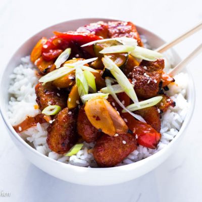 A super delicious and simple vegetarian baked sweet and sour chicken recipe that is sure to please even the biggest meat eaters! Best of all it is loaded with tons of healthy and crunchy roasted vegetables and no frying is necessary!