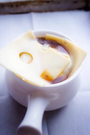 Swiss cheese layered on the soup crock
