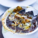 Spoon holding cheese from French Onion soup; - Girl and the Kitchen