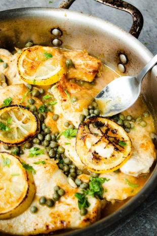 Low Carb Chicken Piccata with the sauce being spooned