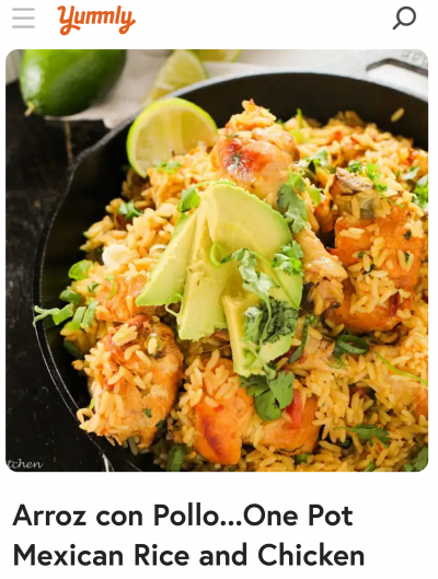 Yummly arroz con pollo recipe with picture of rice and chicken on a dark plate with limes and avocado